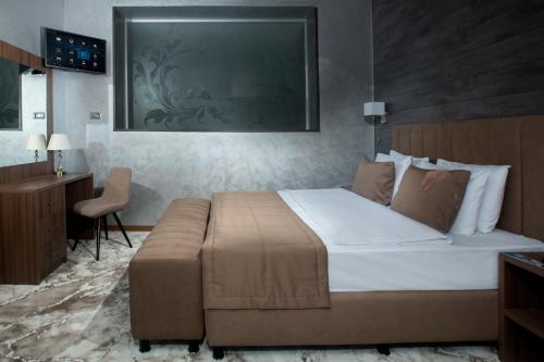 Кровать или кровати в номере ТЭС Отель