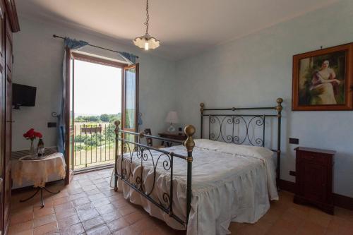 a bedroom with a bed and a large window at Agriturismo La Gismonda in Bracciano