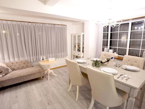 a living room with a table and chairs and a couch at 4 bedrooms cozy house, 5 min JR train to Shinjuku, GRADIA Koenji in Tokyo