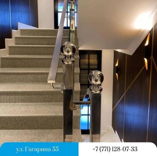 a set of stairs with two silver skulls on them at Kaspi Hotel in Uralsk
