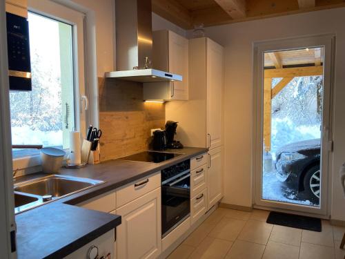 a kitchen with a sink and a stove at Oachkatzlschwoaf in Arnoldstein
