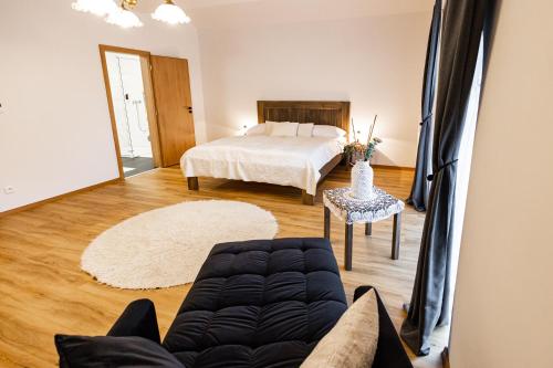 a living room with a bed and a couch at Pivovar Tupadly in Tupadly