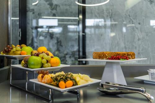 a buffet with three plates of food on display at Congress Hotel in Vilnius