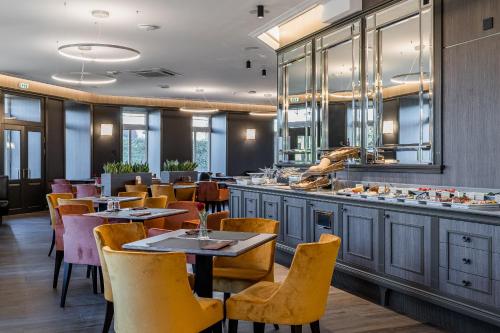 a restaurant with tables and chairs and a bar at Congress Hotel in Vilnius