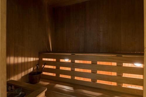 a sauna with the sun shining through a window at Congress Hotel in Vilnius