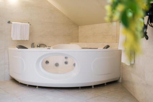 a bathroom with a tub and a sink at Congress Hotel in Vilnius