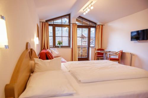 a hotel room with a bed and a window at Feriendorf Ponyhof in Fusch an der Glocknerstraße
