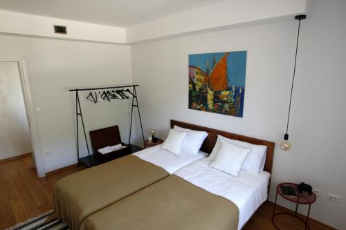 a bedroom with a bed and a painting on the wall at Villa Piano - Učka Nature Park in Lupoglav