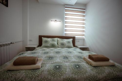 a bedroom with a large bed with two pillows at Apartman Vesna in Nova Varoš