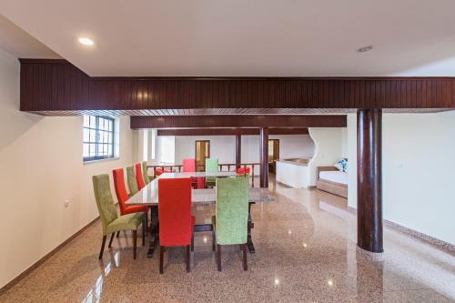 a dining room with a table and colorful chairs at Douro House Loft in Tabuaço