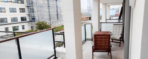 a balcony with a table and chairs on a building at Business Apartment Velizy Free parking by Servallgroup in Vélizy-Villacoublay