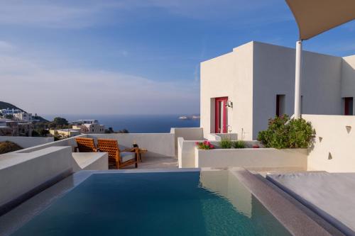 a swimming pool on the roof of a house at Potnia Theron Suites in Akrotiri