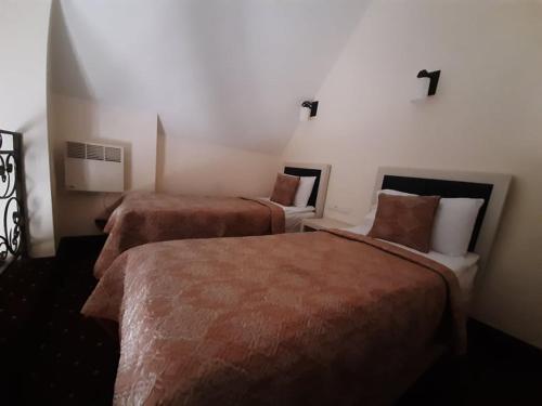 a hotel room with two beds in a room at Jermuk Verona Resort in Jermuk