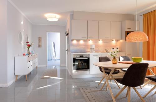 a kitchen and dining room with a table and chairs at "Villa Sonnengarten", FeWo 3 in Boltenhagen