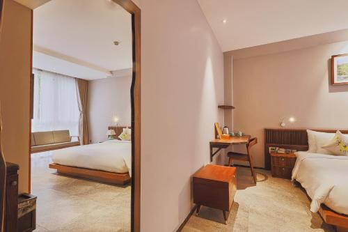 a hotel room with a bed and a mirror at CHERRY BOUTIQUE HOTEL in Ho Chi Minh City