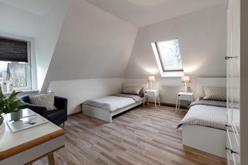 a living room with two beds and a couch at Arkadia-Home-Hamburg-Airport-Apartment in Hamburg