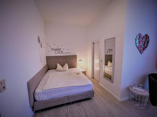 a bedroom with a bed in a white room at Arena Hotel in Gelsenkirchen