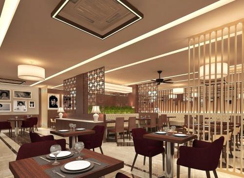 a rendering of a restaurant with tables and chairs at Sai Maa Hotel & Residency in Puttaparthi