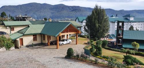 an aerial view of a house with a car at Tea Bush Hotel in Nuwara Eliya