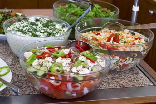 a group of bowls of salad on a counter at Hotel Europe in Paralia Katerinis