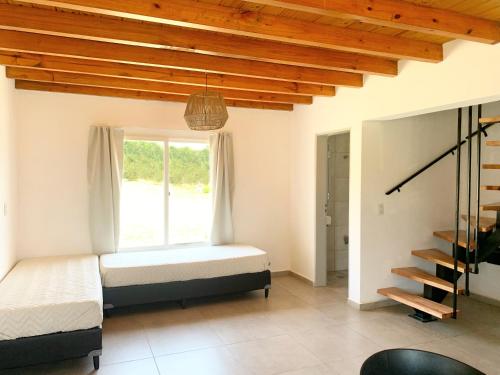a bedroom with a bed and a window at Cabañas Sonnenblumen in Potrero de Garay