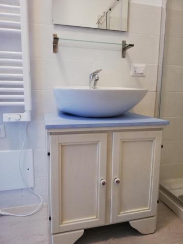 a sink on top of a cabinet in a bathroom at Suite Smeralda sea view in Castelsardo