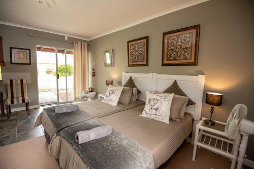 a bedroom with a large bed with pillows on it at Tenikwa Wildlife Centre & Spa in Plettenberg Bay