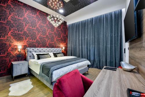 a bedroom with a bed and a red wall at Florek & Florica Room001 in Križevci
