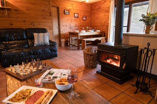 a living room with a woodburning stove in a house at Turon Gates - Mountain Retreat in Capertee