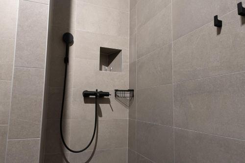 a shower with a shower head in a bathroom at SAVOY residence in Osijek