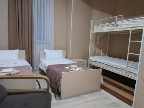 a room with two beds and a bunk bed at AnSeZa in Kutaisi