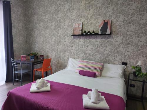 a bedroom with a bed with two towels on it at Bnbook Residence La Red in Rho