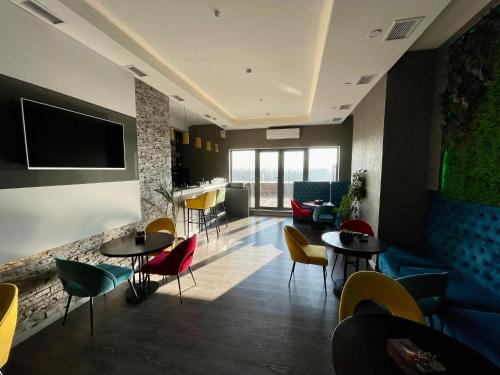 a restaurant with tables and chairs and a bar at Terrasse Hotel & Bar in Bishkek