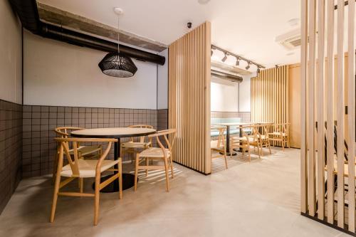 a dining room with wooden tables and chairs at Hospedium H Cabo Sport in Finisterre