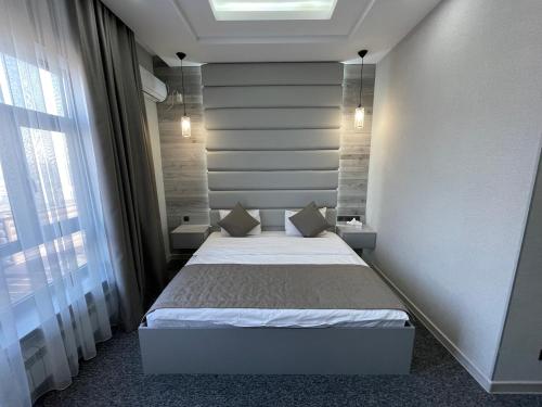 a small bedroom with a bed in a room at Terrasse Hotel & Bar in Bishkek