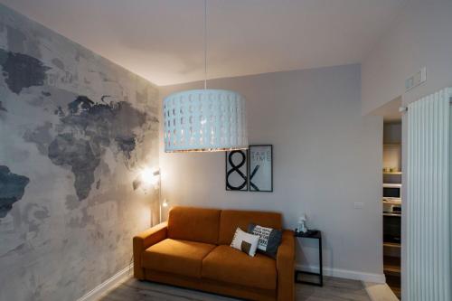 a living room with a couch and a pendant light at Livingstone B&B in Matera