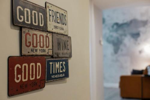 a group of signs hanging on a wall at Livingstone B&B in Matera