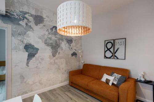a living room with a couch and a world map mural at Livingstone B&B in Matera