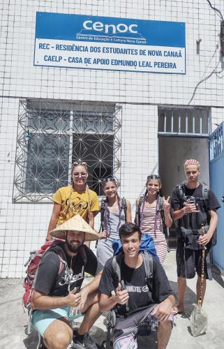 a group of people posing in front of a building at C&R Hostel Residencial in Salvador