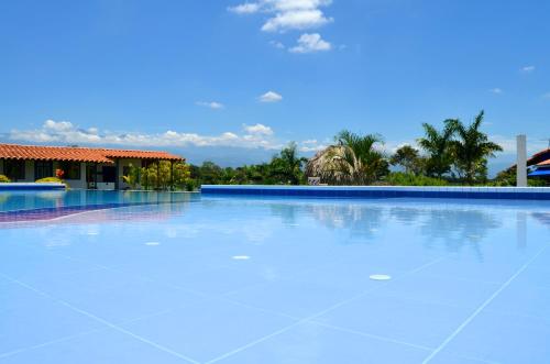 a large blue swimming pool with a building in the background at Finca Azulinas in La Tebaida