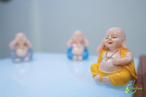 a plastic figurine of a woman in a yellow robe at Lime Tree Hotel Near 32nd Avenue Sector 29 Gurgaon in Gurgaon