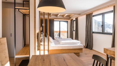 a room with a bed and a table in it at Im Wiesengrund Apartments in Sesto