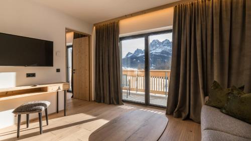 a living room with a view of a mountain at Im Wiesengrund Apartments in Sesto