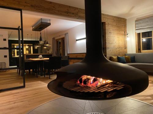 a living room with a fire place in a living room at Chalet am Wetterkreuz in Reit im Winkl