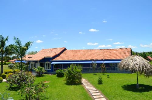 a blue house with a garden in front of it at Finca Azulinas in La Tebaida