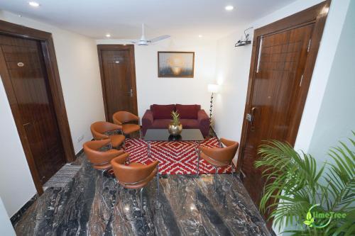 a living room with a group of chairs and a couch at Lime Tree Hotel Near 32nd Avenue Sector 29 Gurgaon in Gurgaon