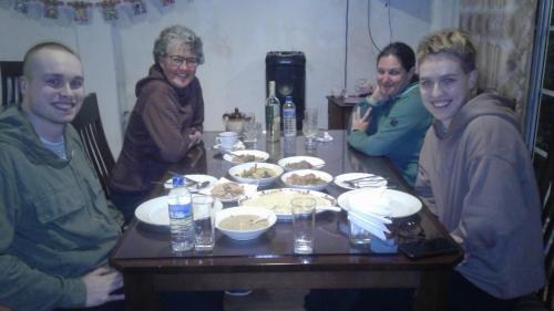 a group of people sitting around a table with food at Zion in Nuwara Eliya