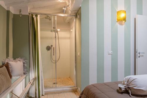 a bathroom with a shower and a bed and a room at Casa Margherita, Residenze Seicento - Stunning view from terrace. in Lucca