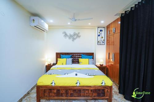 a bedroom with a bed and a black curtain at Lime Tree Hotel Near 32nd Avenue Sector 29 Gurgaon in Gurgaon