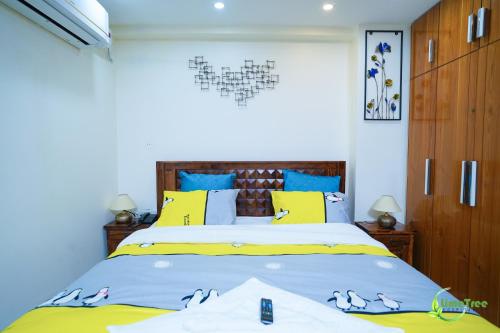 a bedroom with a bed with a heart on the wall at Lime Tree Hotel Near 32nd Avenue Sector 29 Gurgaon in Gurgaon